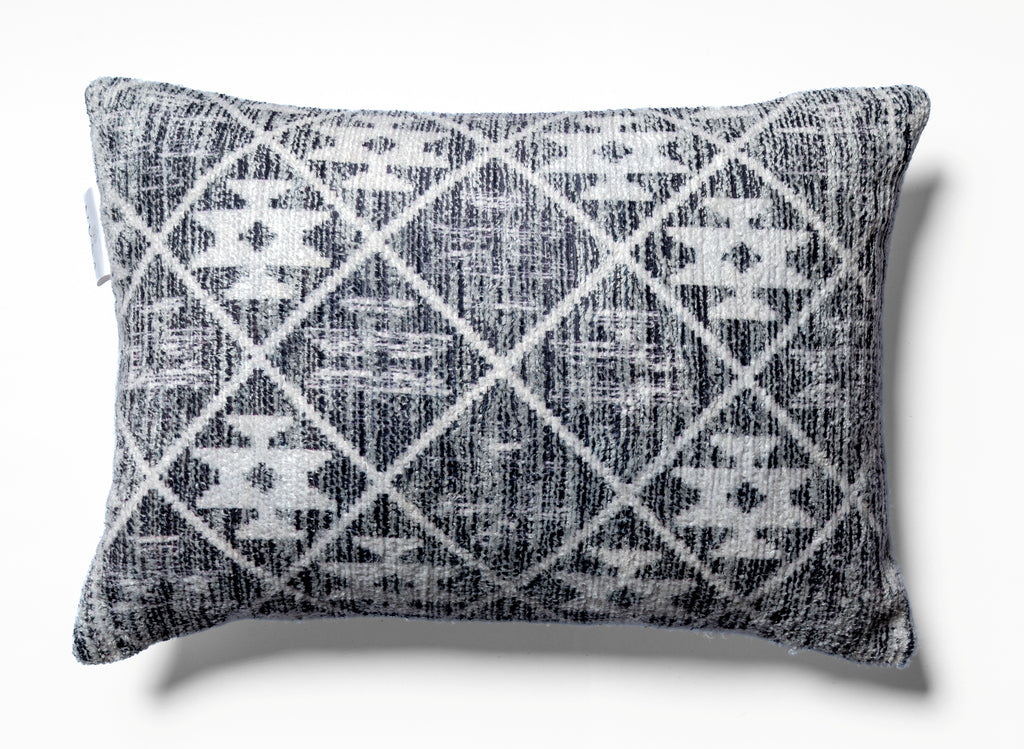 Vellum Noir 13x19 boudoir cushion styled on a cream contemporary sofa